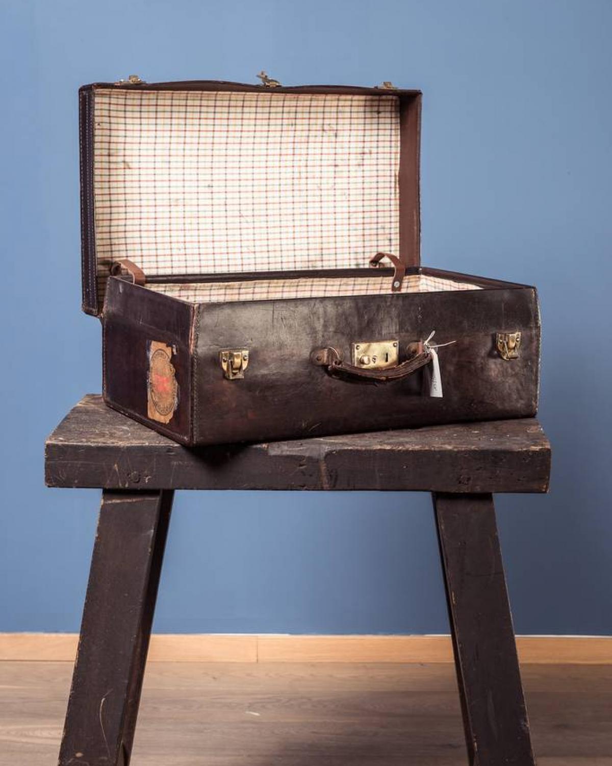 Leather suitcase with travel labels (1 of 1)