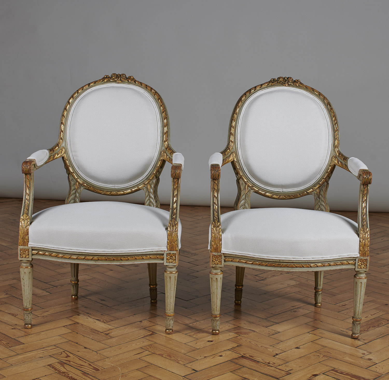 Pair of French Louis XVI Style Painted and Gilt Cabriolet Armchairs. (1 of 1) Pair of French Louis XVI Style Painted and Gilt Cabriolet Armchairs. (1 of 1)