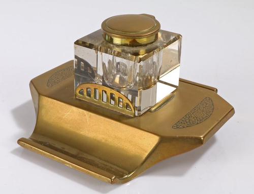 Art Deco brass and glass inkwell, the hinged brass lid above a clear glass body and brass base with two pen trays and engraved foliate scroll decoration, (1 of 12)