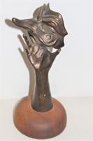 A bronze masquerade theatrical mask being held by a hand (6 of 9) A bronze masquerade theatrical mask being held by a hand (6 of 9)