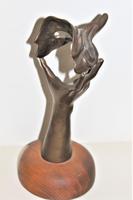 A bronze masquerade theatrical mask being held by a hand (5 of 9) A bronze masquerade theatrical mask being held by a hand (5 of 9)