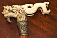 A finely carved large and chunky Chinese bone walking stick depicting a dragon with a loose ball in its mouth (4 of 6) A finely carved large and chunky Chinese bone walking stick depicting a dragon with a loose ball in its mouth (4 of 6)