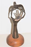 A bronze masquerade theatrical mask being held by a hand (8 of 9) A bronze masquerade theatrical mask being held by a hand (8 of 9)