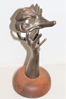 A bronze masquerade theatrical mask being held by a hand (2 of 9) A bronze masquerade theatrical mask being held by a hand (2 of 9)