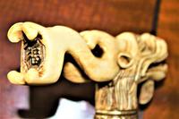 A finely carved large and chunky Chinese bone walking stick depicting a dragon with a loose ball in its mouth (5 of 6) A finely carved large and chunky Chinese bone walking stick depicting a dragon with a loose ball in its mouth (5 of 6)