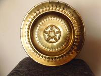 An arts and crafts brass charger An arts and crafts brass charger