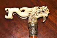 A finely carved large and chunky Chinese bone walking stick depicting a dragon with a loose ball in its mouth (2 of 6) A finely carved large and chunky Chinese bone walking stick depicting a dragon with a loose ball in its mouth (2 of 6)